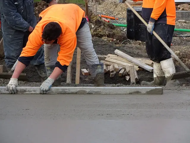 man pouring a concrete patio